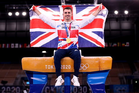 Max Whitlock sat on pommel horse with union jack