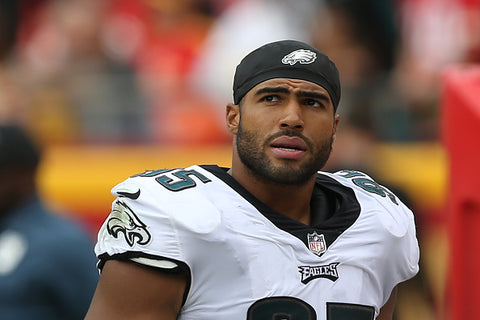 Mychal Kendricks in white top and black hat