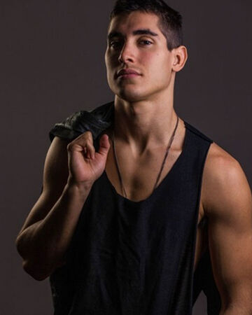 Henry Zaga in black vest muscled arms