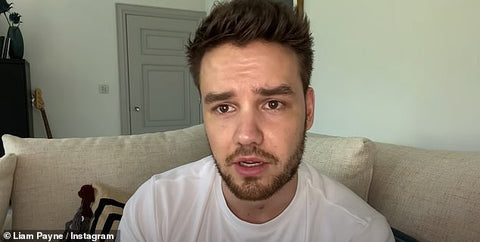 liam payne sits on couch with white tshirt