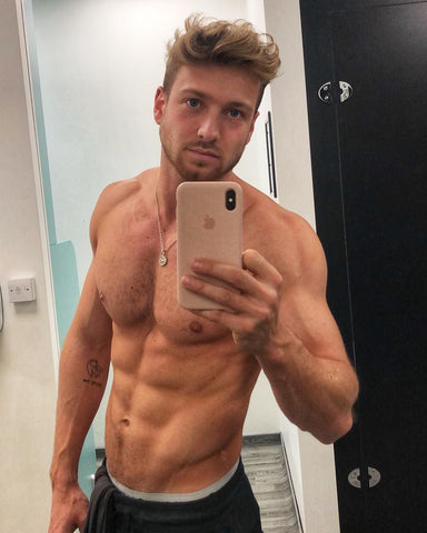 Sam Thompson takes a mirror selfie topless with buff bod
