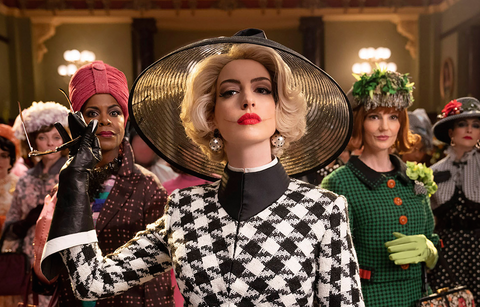Anne Hathaway in houndstooth outfit and hat with blonde hair