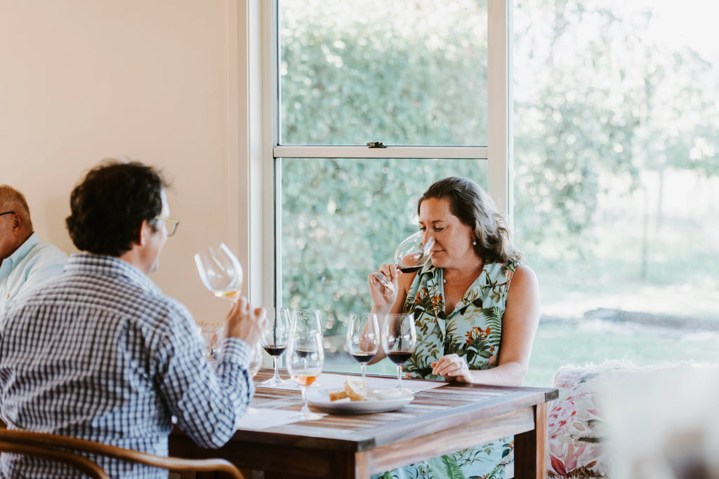 Couple enjoying wine tasting at indoor table