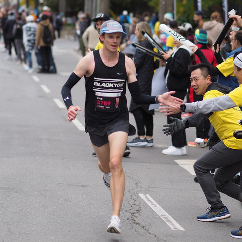 person running and getting a high five