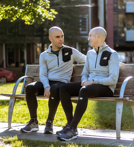couple sitting on a bench in running gear