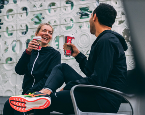 Friends sharing coffee on a bench