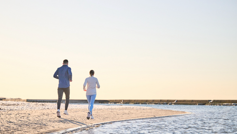 two runners on the beach in On Running Cloudsurfer shoes