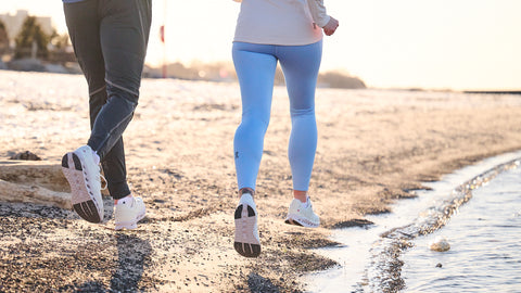 Two runners on the beach in On Running Cloudsurfer running shoes