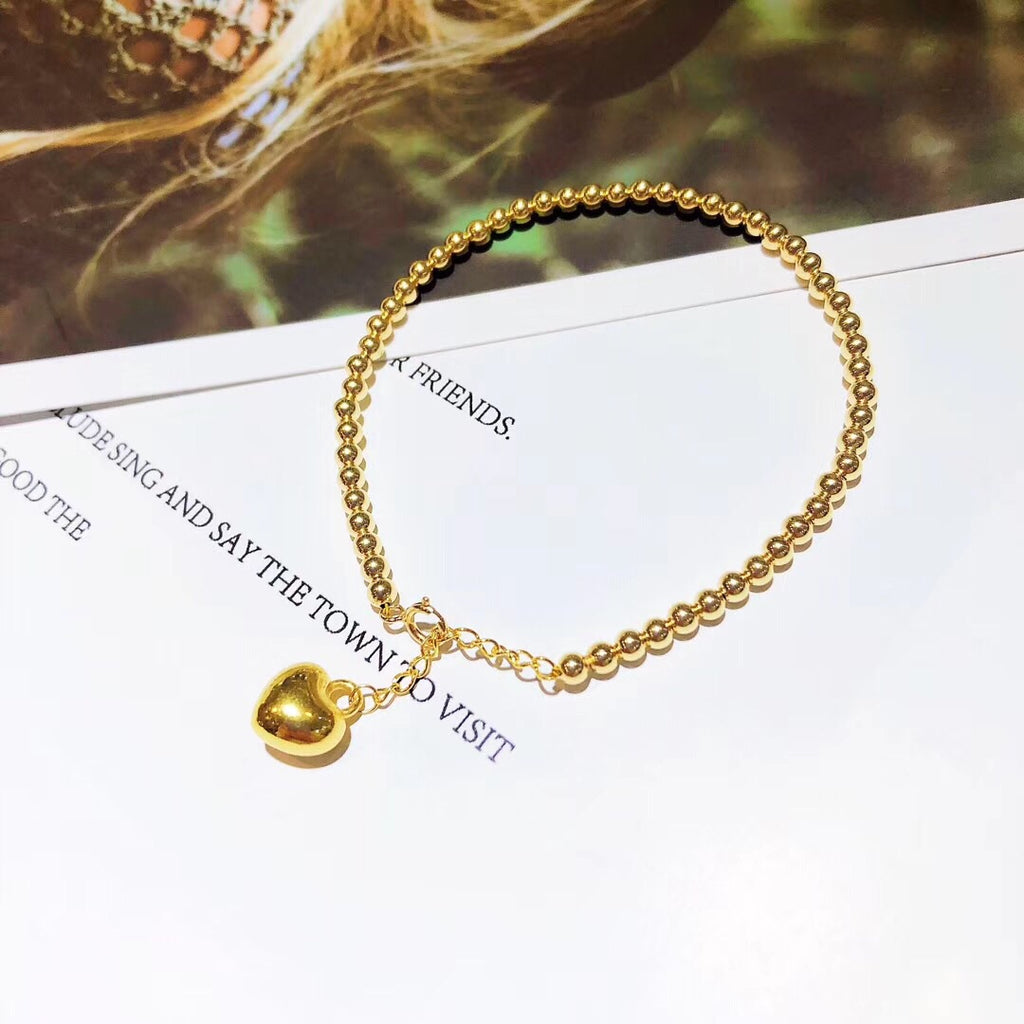 gold bracelet with heart charm