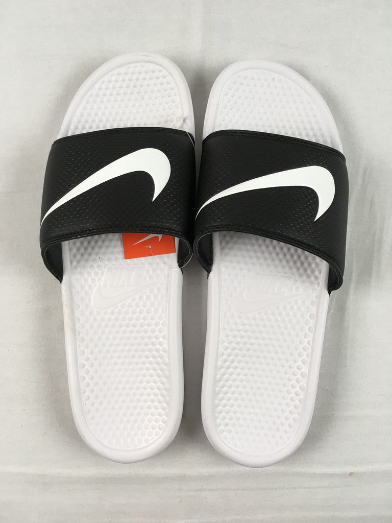 black nike slides with white swoosh