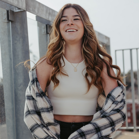 Young woman with long, curled hair laughing