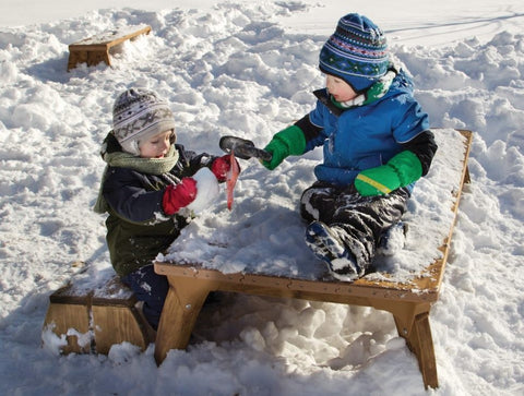children in childcare or daycare playing in snow on Outlast table and bench