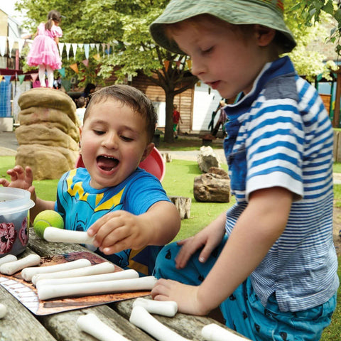 Children are playing with dinosaur bones  on a sunny day outside