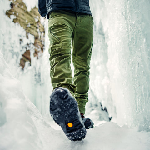 man wearing green water-repellent cargo pants in ice caves