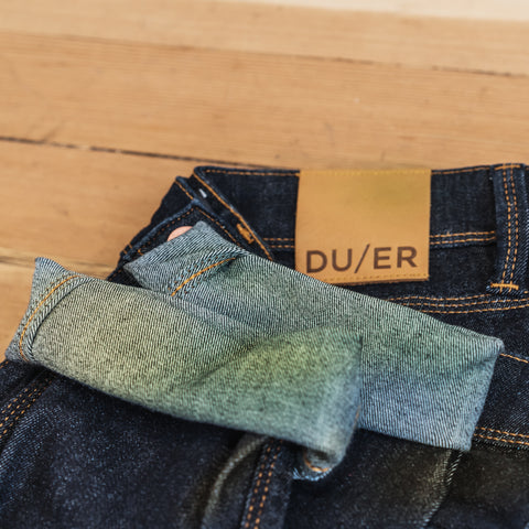 A pair of grass-stained DUER Denim