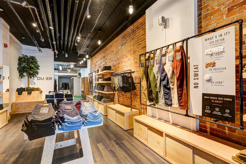 The Toronto DUER store's interior with denim stacked neatly on tables