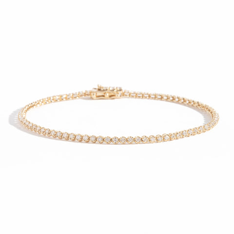 14 carat yellow gold tennis bracelet featuring round brilliant cut white diamonds