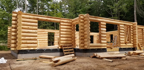 Beginning of a new construction log home, 12" white cedar logs