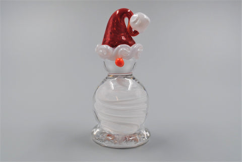 A single glass snowman with a small orange nose. Its stocking cap is red with a white brim and white pom pom on the end. Its body is made of swirled clear and white glass and its head is made of clear glass. 