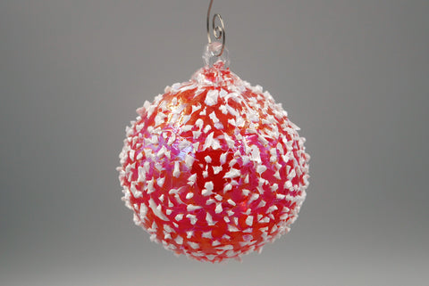 One cherry red blizzard ornament hanging from an ornament hook