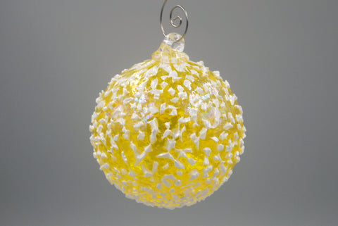 One yellow blizzard ornament hanging from an ornament hook