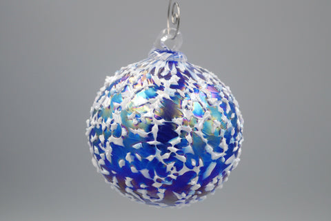 One cobalt blue blizzard ornament hanging from an ornament hook