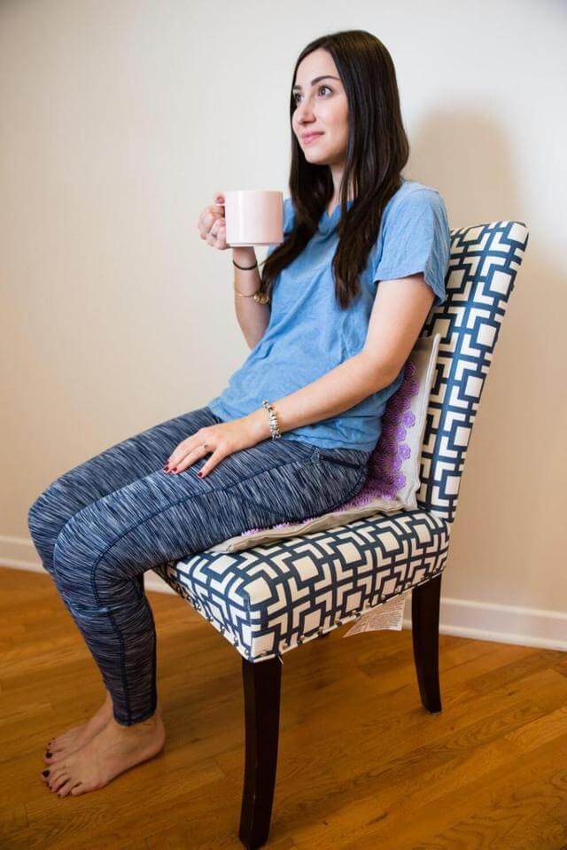 woman sitting on Dosha Mat lavender acupressure  mat