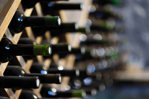 wine stored horizontally in a wood rack