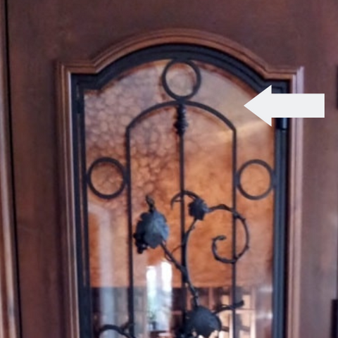 Arrow pointing at the glass etching on a wine cellar door