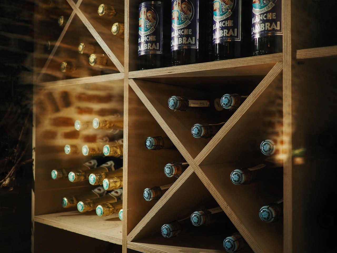 Blanche Cambrai bottles organized in a wooden wine rack