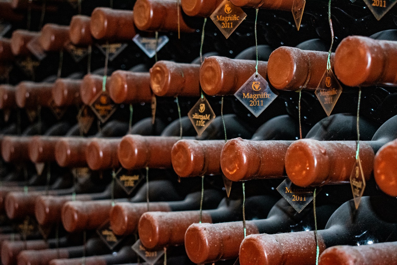 Organized tagged wine bottles stored sideways 