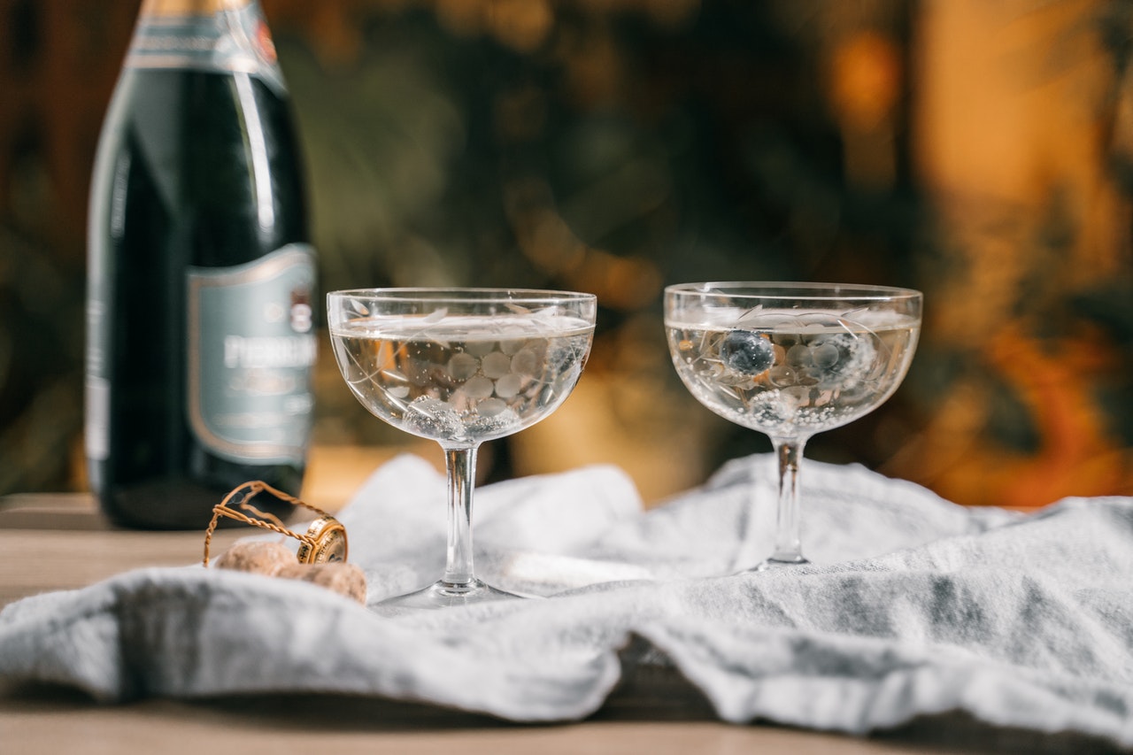 Bottle of wine and two vintage wine glasses with white wine