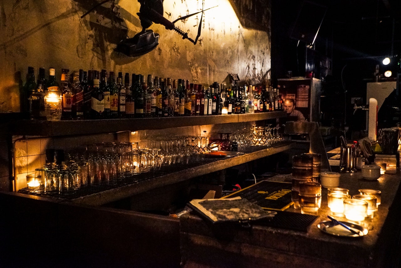 Bar with wine bottles and glasses on the shelf with lighting