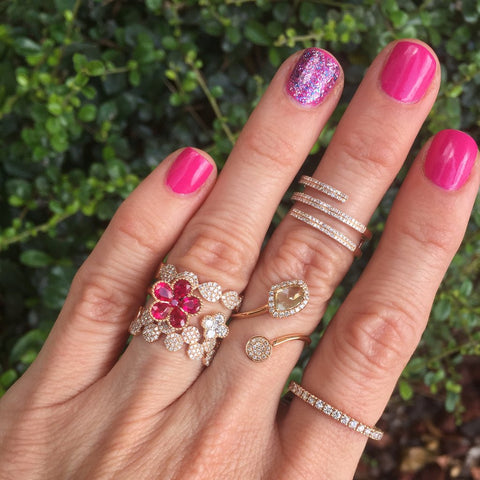 mixture of different types of diamond and rose gold stacking rings. 