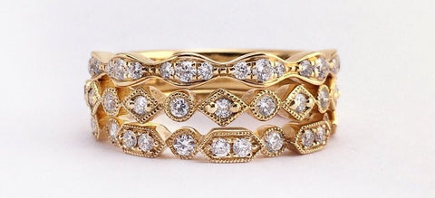 image of yellow gold and diamond stacked engagement and wedding rings. 