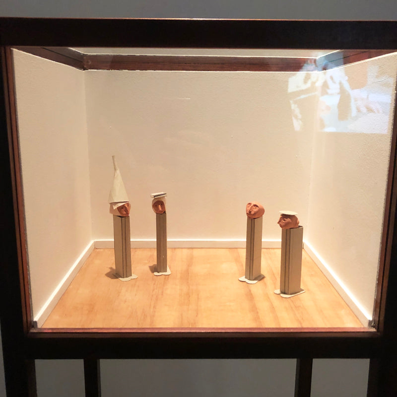 A display cabinet containing figures made out of Pez cartons