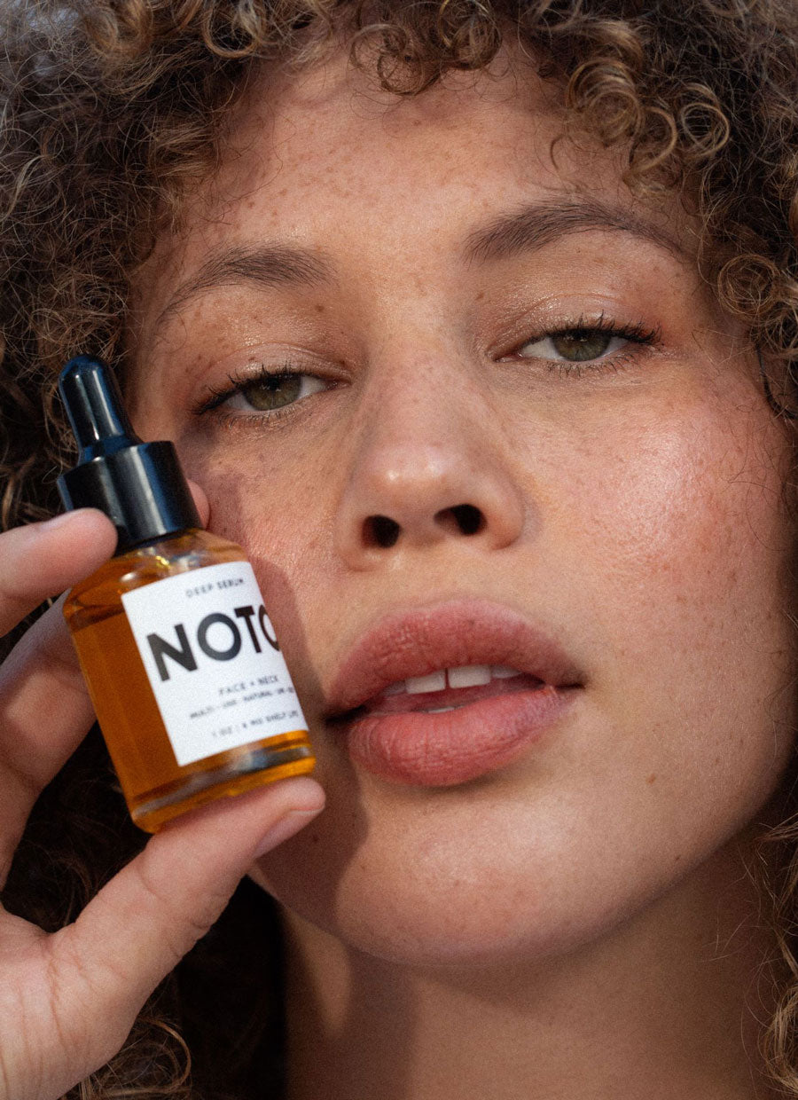 A woman holding NOTO Deep Serum