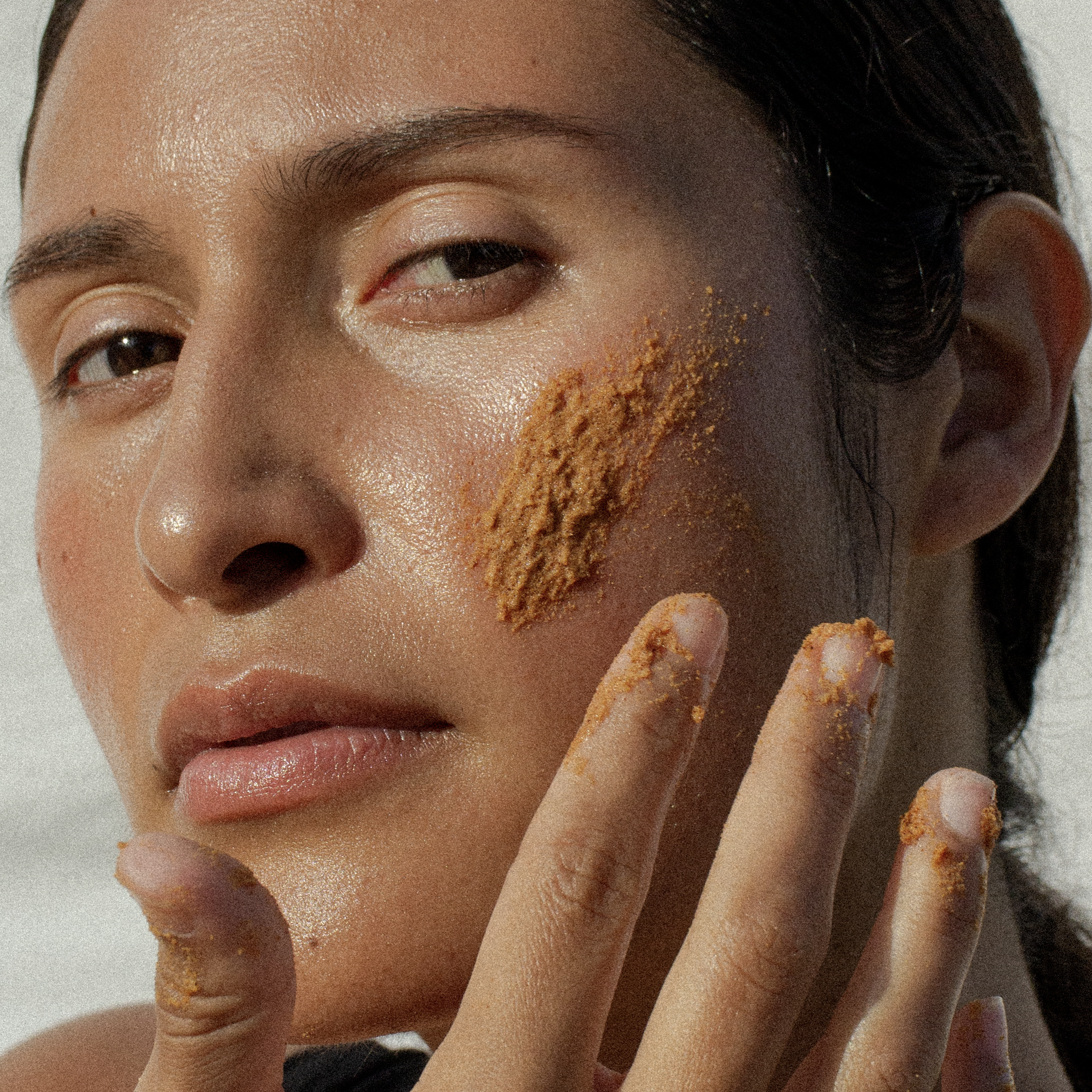 A person applying face scrub