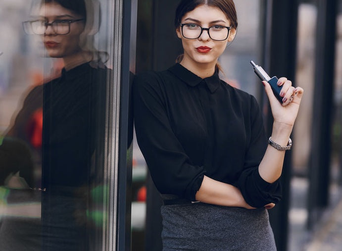 A woman enjoys a quiet moment with her vape.