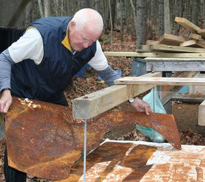 Bob Hainstock removing rust print off hydraulic press for art in Nova Scotia