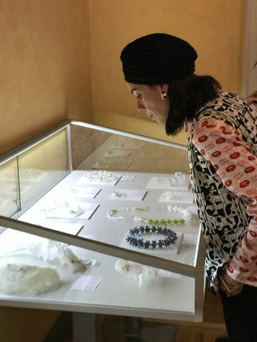 Woman looking at contemporary jewelry in a box - IndieFaves