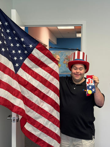 John Cronin proudly holds our Mismatched Flag Crew Socks while celebrating the Fourth of July in true patriotic style.