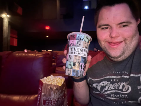 John with a Taylor Swift cup at the Taylor Swift movie