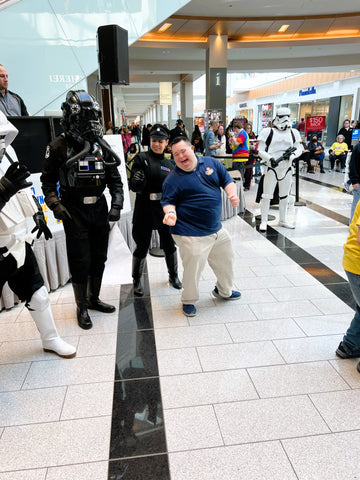 John with star wars characters at World Down syndrome day event 