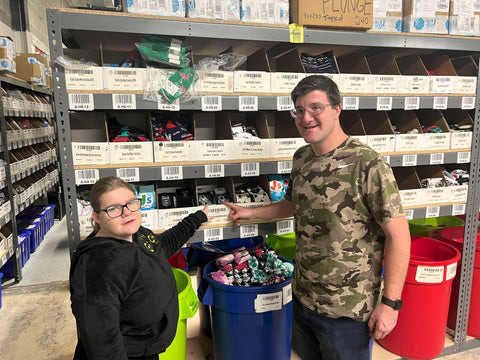 John schneider showing Camryn how to pick sock orders