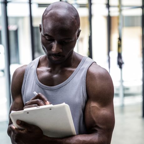 lean man writing on a notepad