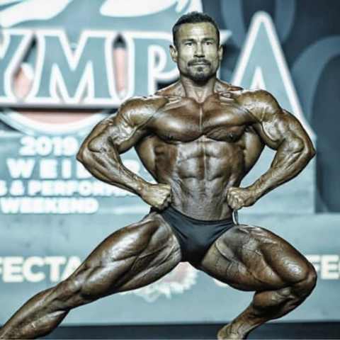 https://cdn.shopify.com/s/files/1/1633/7705/files/mr_olympia_open_vs_classic_480x480.jpg?v=1672236702