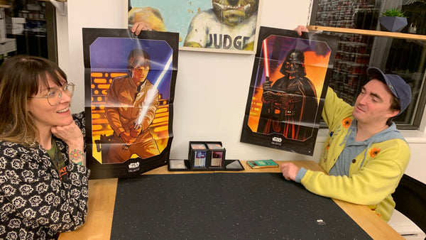 Morgan and Alex hold Luke Skywalker and Darth Vader posters
