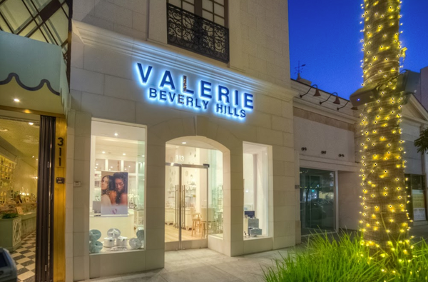 Front view of Valerie Beverly Hills located at 313 N Beverly Drive. Two large glass windows frame the entry way doors. Entrance is two large glass doors.