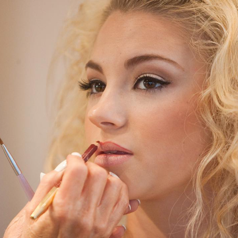 Valerie applying deep cherry lip liner, a deep warm red shade.